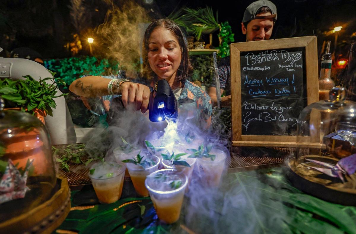 Lexi Tollinchi, with Better Days, prepares cocktails during the Art of Tiki Cocktail Showdown at the South Beach Wine & Food Festival at the Kimpton Surfcomber Hotel in Miami Beach, Florida on Saturday, February 25, 2023.