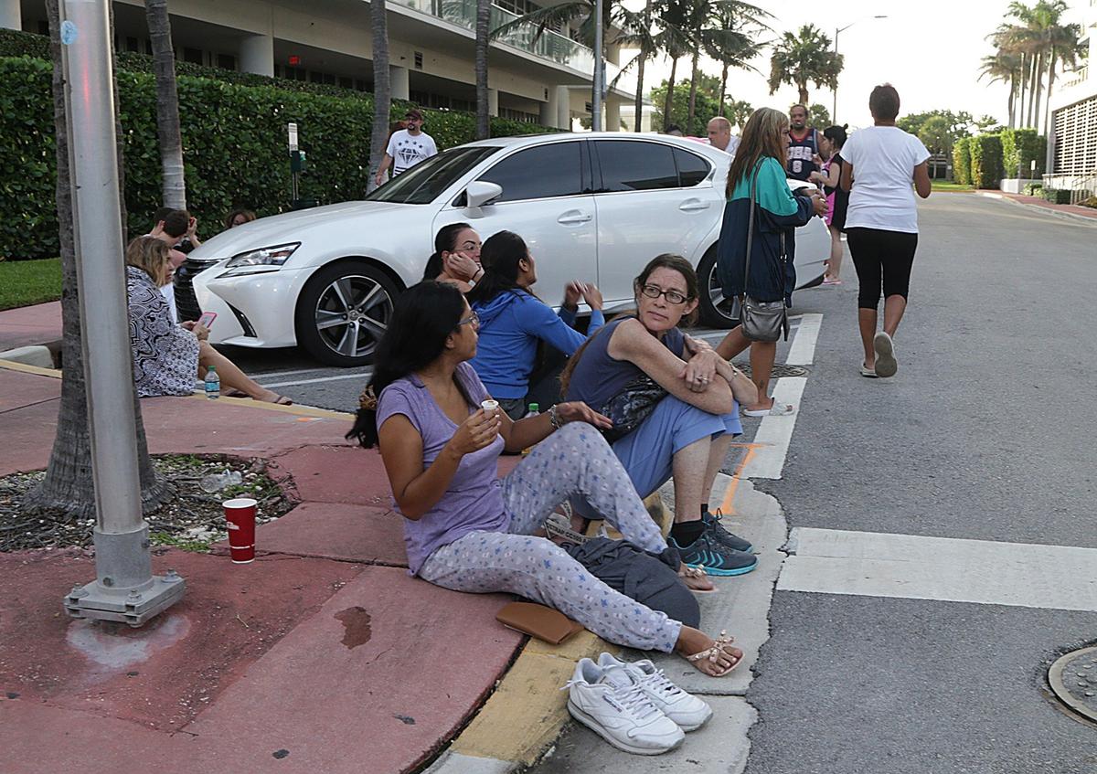 Residents, including Miami Herald food writer Linda Bladholm (second from left), wait outside on the street as City of Miami Beach Fire units extinguished a fire in a building located at 3621 Collins Ave., early morning on Friday, June 1, 2018.