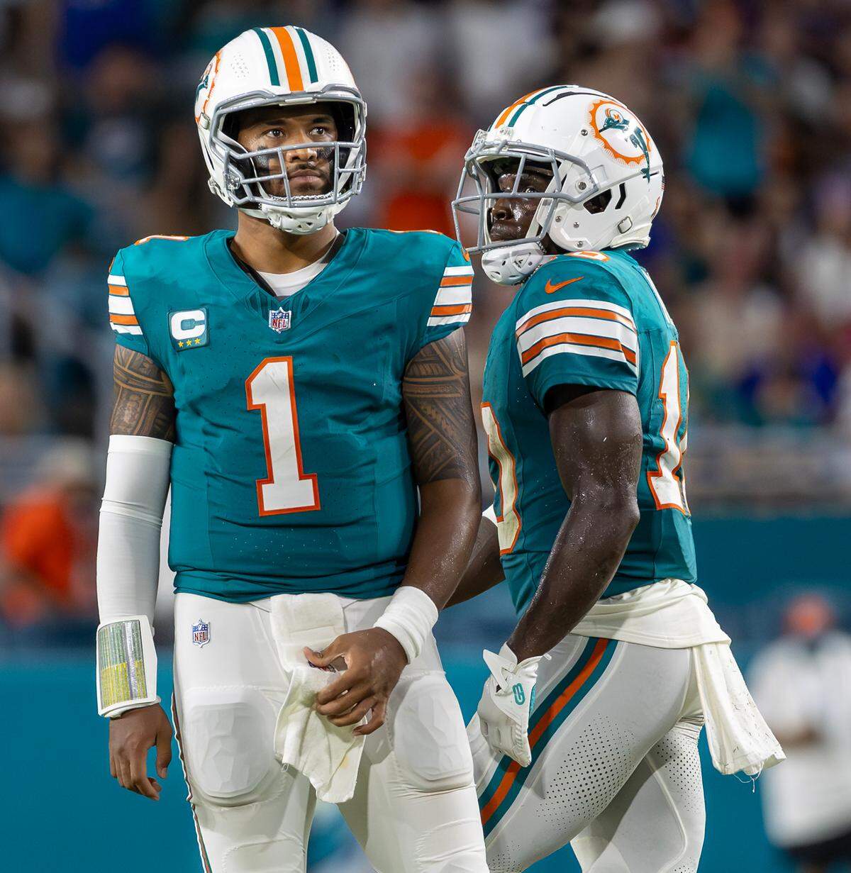 Miami Dolphins quarterback Tua Tagovailoa (1) and Dolphins wide receiver Tyreek Hill (10) react after a play in the first half of their NFL game against the Buffalo Bills at Hard Rock Stadium on Thursday, Sept. 12, 2024, in Miami Gardens, Fla.