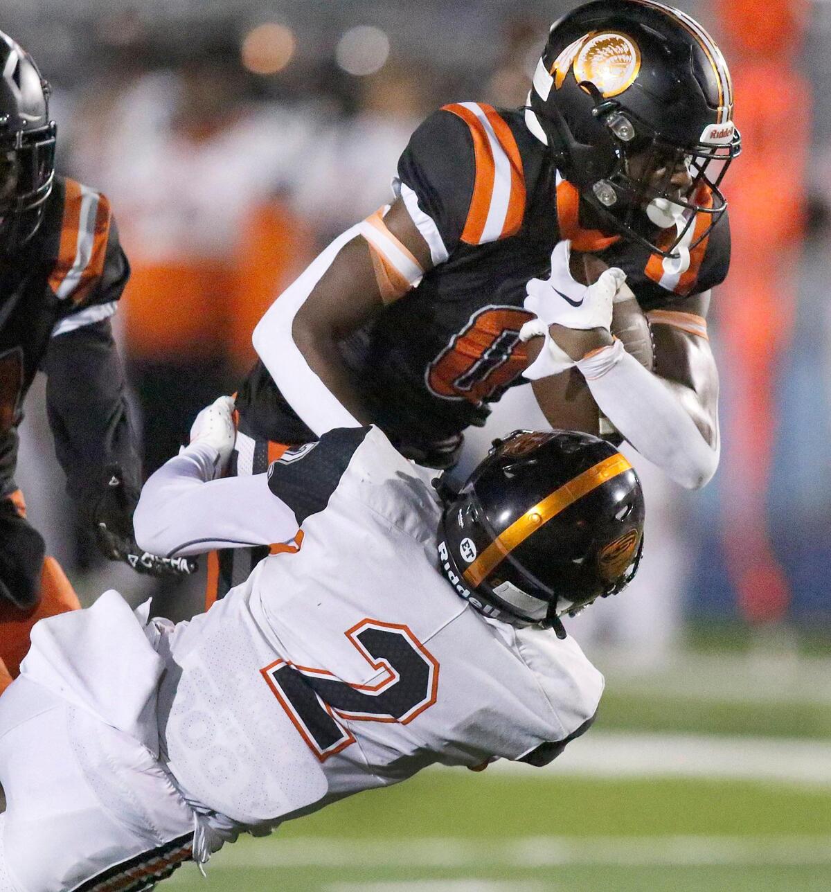 Booker T. Washington Tornadoes Xavier Irvin brings down Carol City Chiefs wide receiver Jahem Guillaume (0) during football game on Friday, September 23, 2022 at Traz Powell Stadium in Miami. Andrew Uloza / for Miami Herald