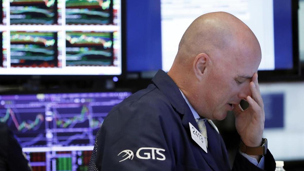 Specialist John O’Hara works on the floor of the New York Stock Exchange on Oct. 11, a day when stocks slumped for a second day as markets endured a volatile stretch.