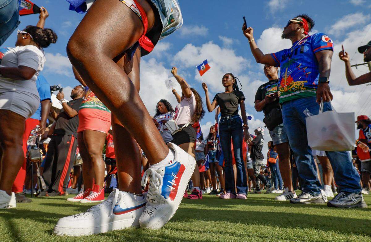 Attendees react as performers sing on stage during the 28th Annual Haitian Compas Festival at The NoMI Village celebrating Haitian Flag Day, in North Miami, Florida on Saturday, May 16, 2026.