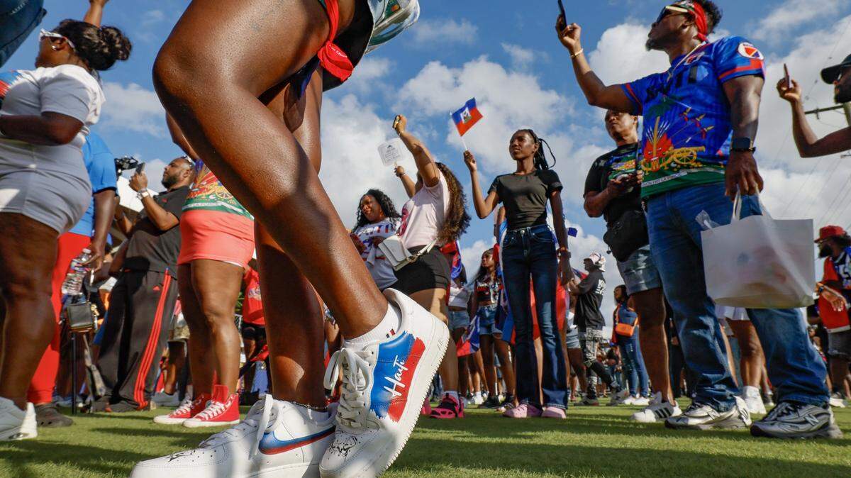 Attendees react as performers sing on stage during the 28th Annual Haitian Compas Festival at The NoMI Village celebrating Haitian Flag Day, in North Miami, Florida on Saturday, May 16, 2026.