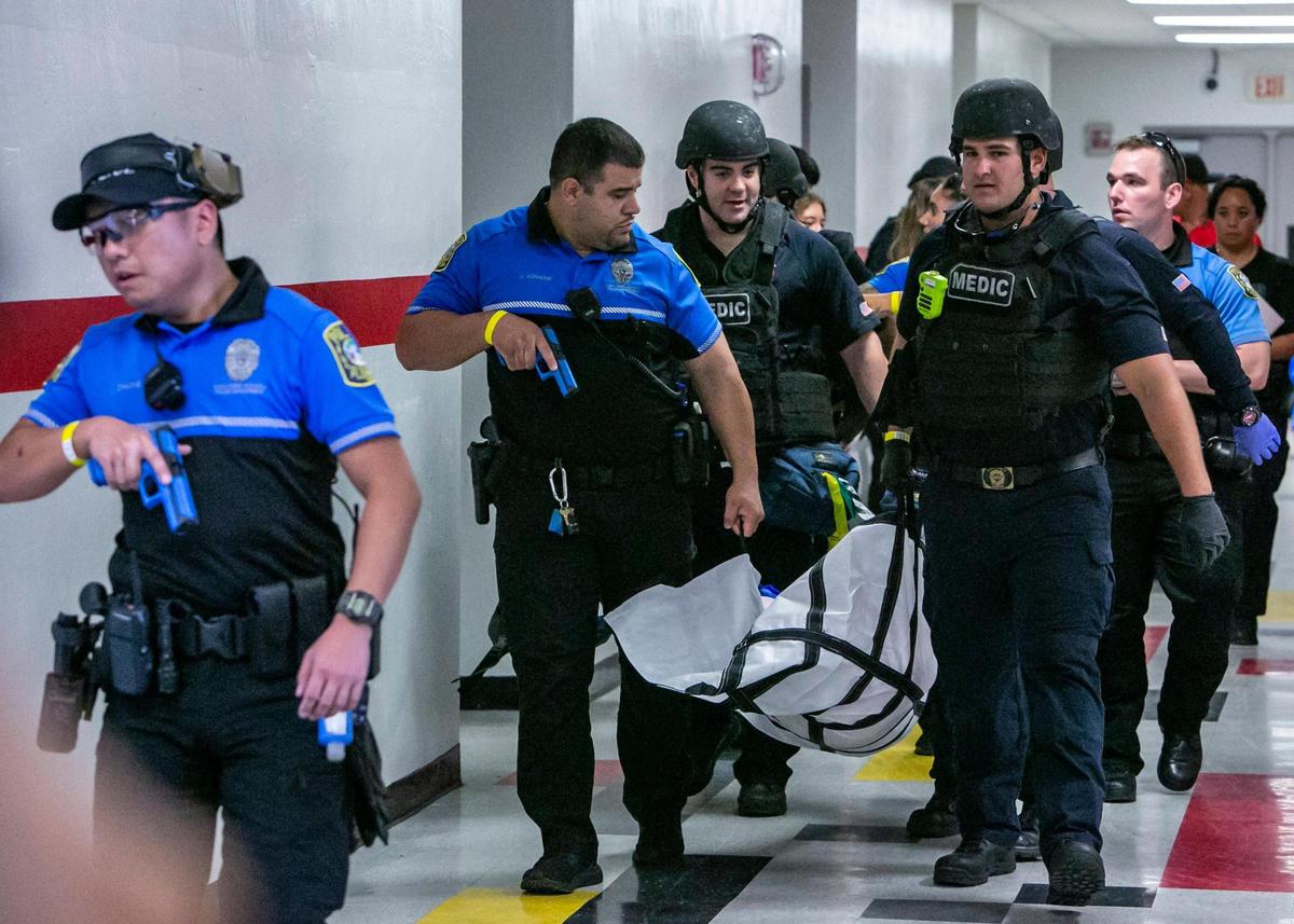 Injured victims are taken out of a classroom by Miami-Dade Schools Police during an active shooter drill held at Coral Gables Senior High School on Friday, July 15, 2022.