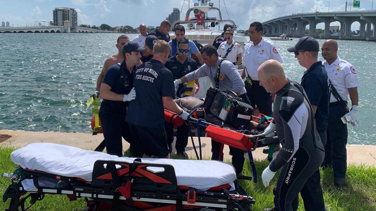 Miami Fire Rescue workers get the man who jumped off the MacArthur Causeway bridge ready for transport to Ryder Trauma Center at Jackson Memorial Hospital