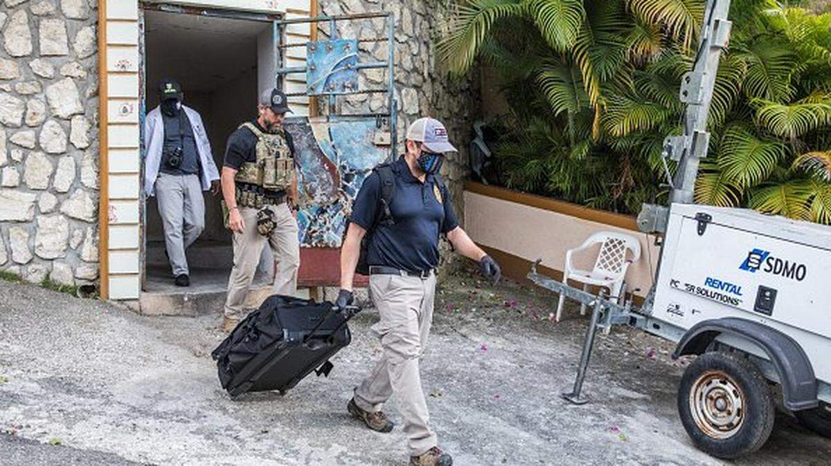 FBI agents exit the residence of late Haitian President Jovenel Moise after conducting searches in Port-au-Prince on July 15, 2021, in the wake of his assassination on July 7, 2021. - The assassination of Jovenel Moise by armed mercenaries was planned in the neighboring Dominican Republic, say Haitian police, who announced the detention of the slain president's chief bodyguard and three other members of his security detail. The United States has sent members of the Federal Bureau of Investigation (FBI), State Department, Justice Department, National Security Council and Department of Homeland Security to Haiti. (Photo by Valerie Baeriswyl / AFP) (Photo by VALERIE BAERISWYL/AFP via Getty Images)