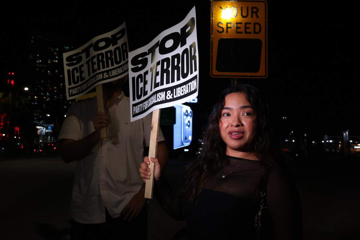 Diana Garcia waves a sign while protesting against ICE at the Torch of Friendship monument at 401 Biscayne Blvd., in downtown on Wednesday, Jan. 7, 2026, in Miami.
