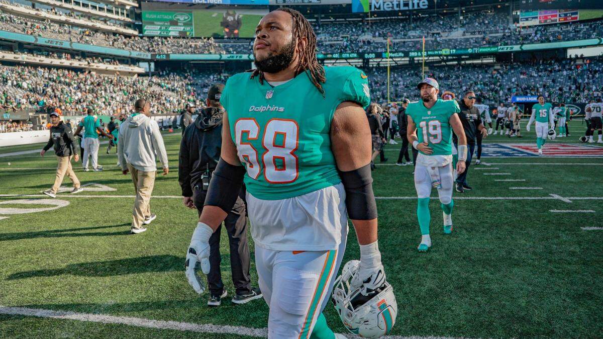 Miami Dolphins offensive tackle Robert Hunt (68) and quarterback Skylar Thompson (19) walk off the field after the New York Jets defeat the Miami Dolphins at MetLife Stadium in in East Rutherford, New Jersey on Sunday, October 9, 2022.