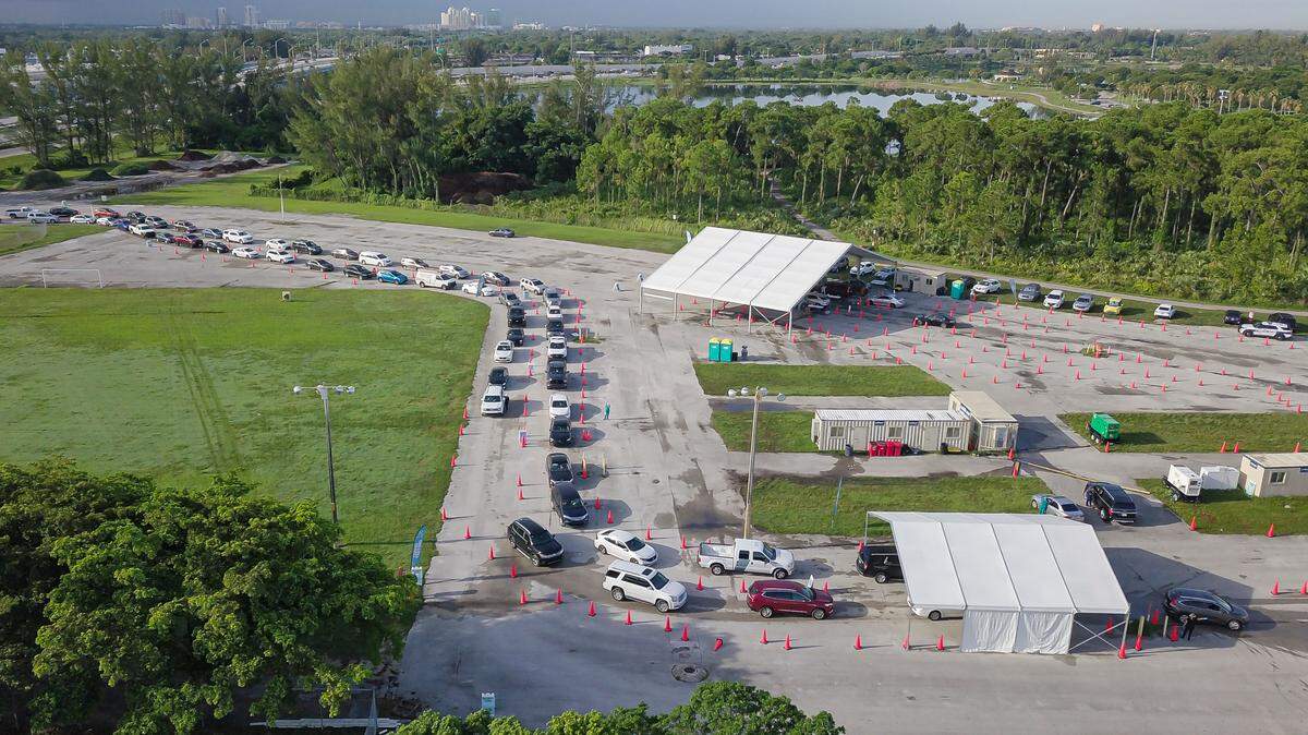Aerial view shows cars lining up at Tropical Park’s COVID-19 testing site in Miami, Florida, on July 30, 2021.