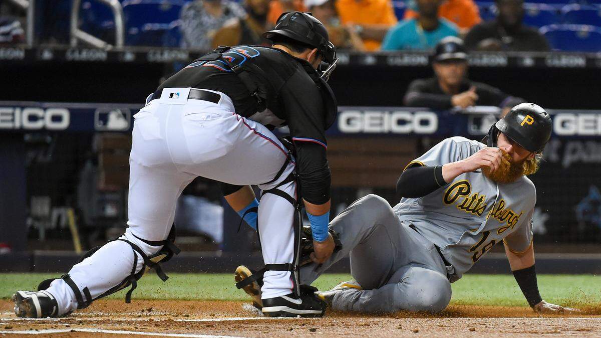 MIAMI, FLORIDA - SEPTEMBER 17: Colin Moran #19 of the Pittsburgh Pirates is thrown out at home plate in the first inning against the Miami Marlins at loanDepot park on September 17, 2021 in Miami, Florida. (Photo by Eric Espada/Getty Images)