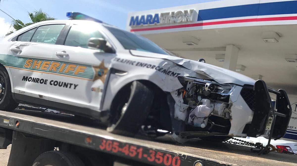 A damaged Monroe County Sheriff’s Office patrol car sits on a flatbed tow truck in front of a Key Largo gas station on Nov. 6, 2018. The crash sent a deputy to the hospital to be treated for minor injuries.