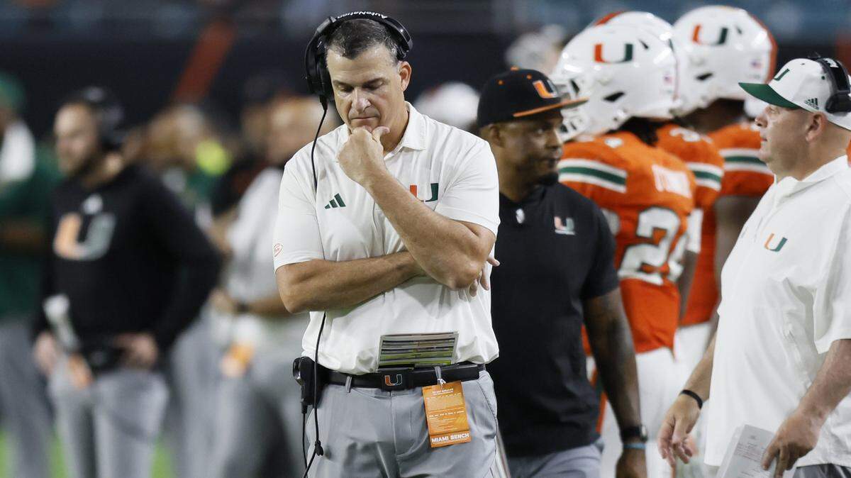 Miami Hurricanes head coach Mario Cristobal walks the sidelines late in thje fourth quarter during the game against the Louisville Cardinals of their NCAA football game at Hard Rock Stadium in Miami Gardens, Florida, on Friday, October 17, 2025. 