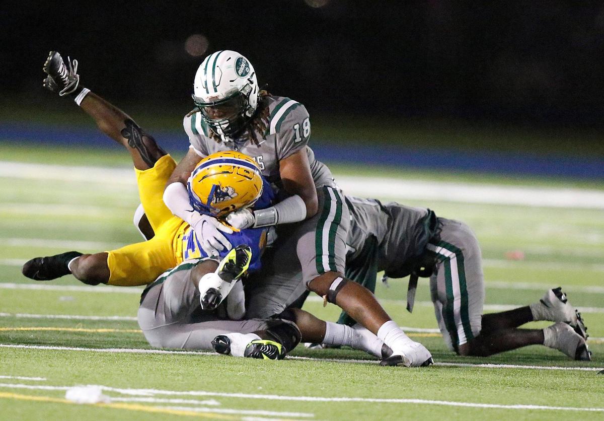 Miami Central Rockets linebacker Lamar Smith tackles Northwestern Bulls running back King Davis (23) on Friday, October 7, 2022 at Traz Powell Stadium in Miami.
