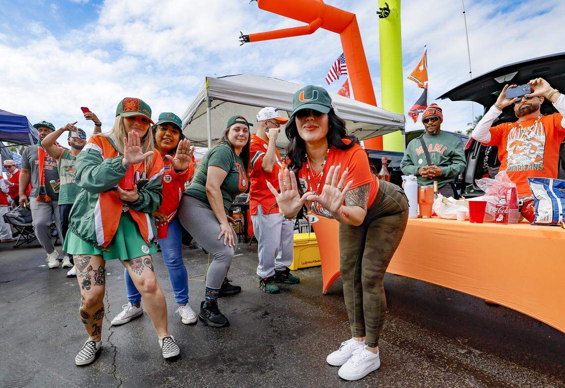 Tailgaters Violet Bottina, Gissela Saa, Aubrey Davis, Melissa Sarduy, left to right, of Miami Lakes and Hialeah, dance and flash the U outside before the College Football Playoff National Championship Game between the Miami Hurricanes and the Indiana Hoosiers at Hard Rock Stadium in Miami Gardens, Florida, on Monday, January 19, 2026.