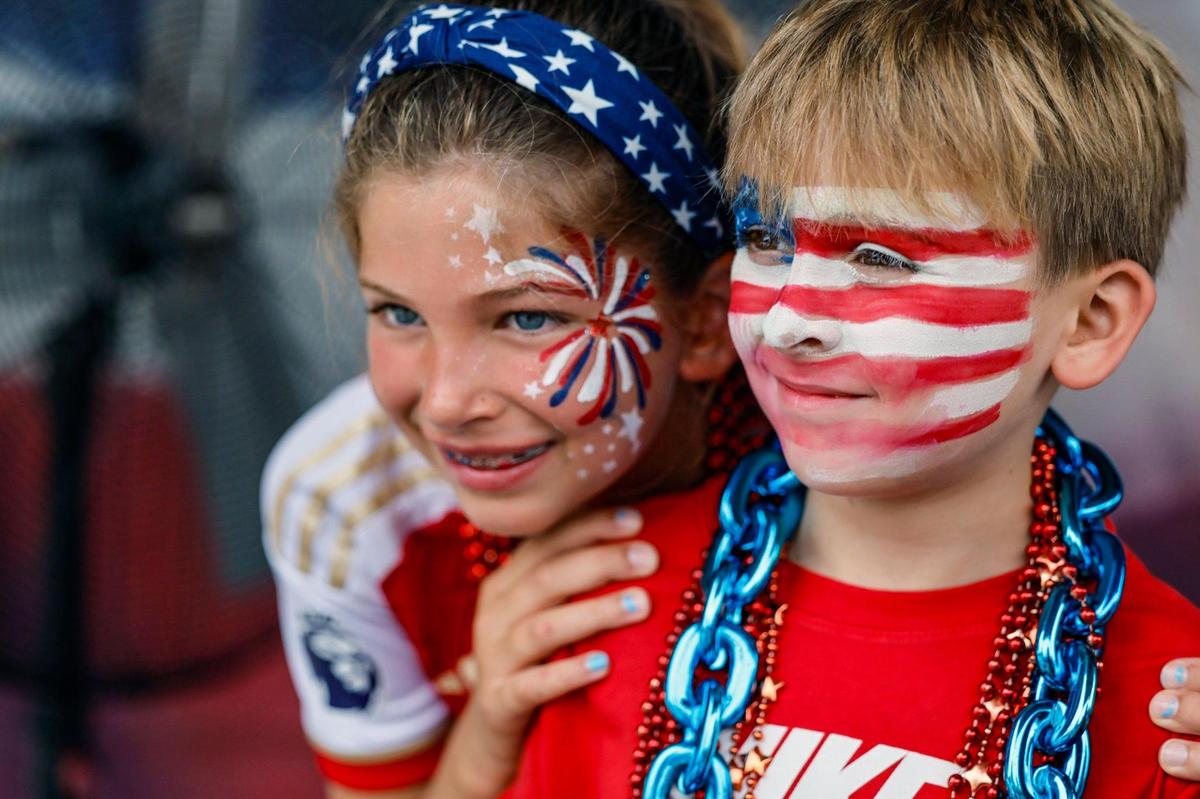 Cousins, Harper Timmerman, 10, and Teddy Tellam, 8, display their patriotic face paintings, as residents, family and friends celebrate Independence Day during the 66th Annual Key Biscayne Fourth of July Parade on Key Biscayne, Florida on Friday, July 4, 2025.