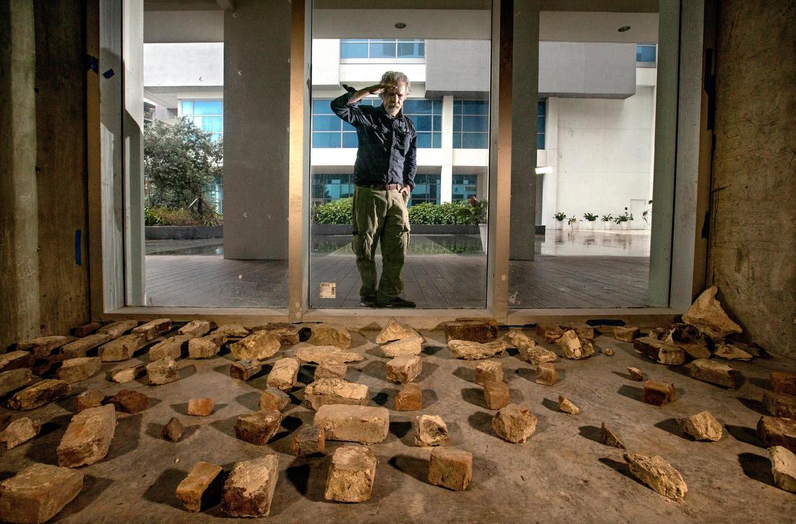 Archaeologist Bob Carr looks through a window of a space where Tequesta artifacts and remnants of the Royal Palm Hotel are stored at Met Square in downtown Miami.