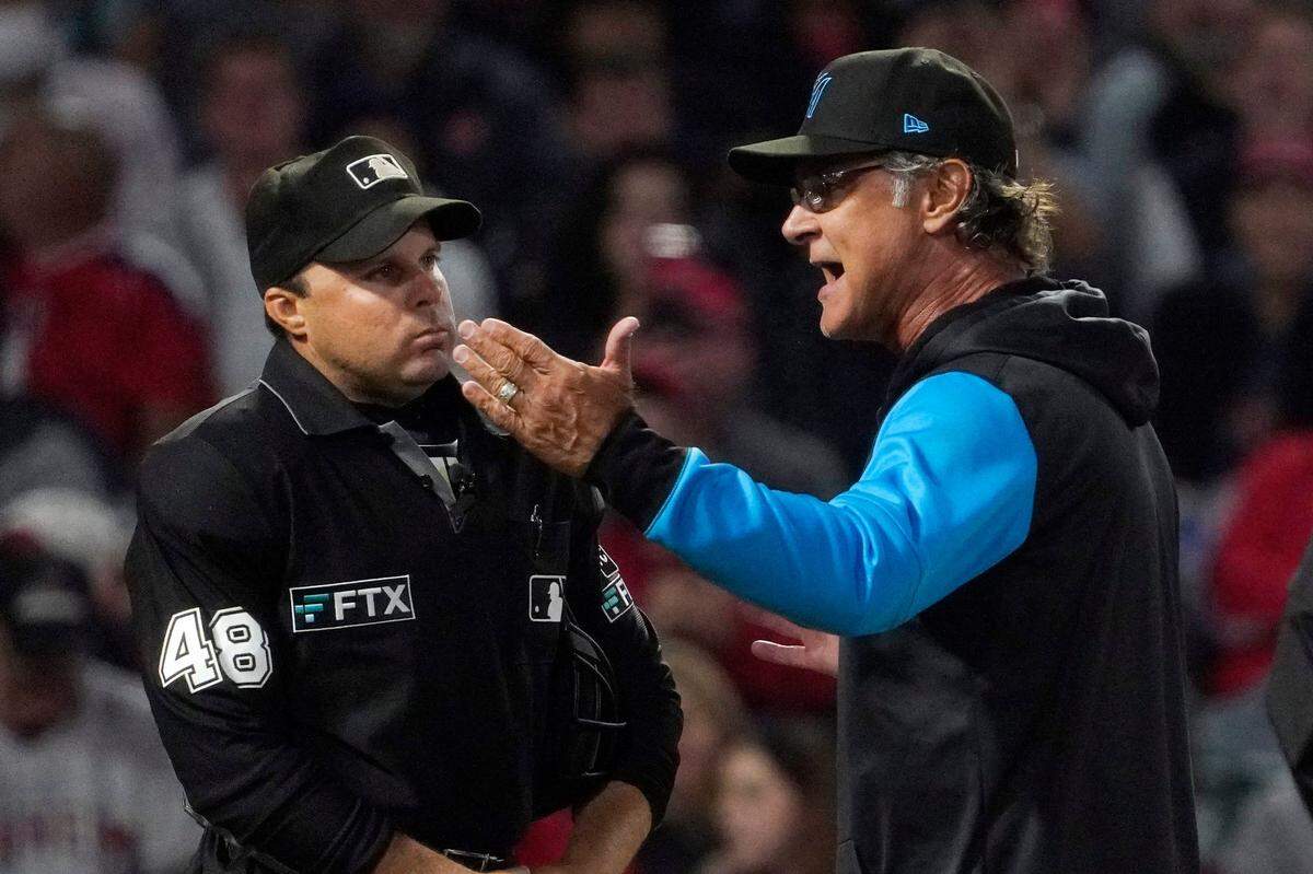 Miami Marlins manager Don Mattingly, right, argues with home plate umpire Nick Mahrley after being ejected during the fourth inning of a baseball game against the Los Angeles Angels Monday, April 11, 2022, in Anaheim, Calif. (AP Photo/Mark J. Terrill)