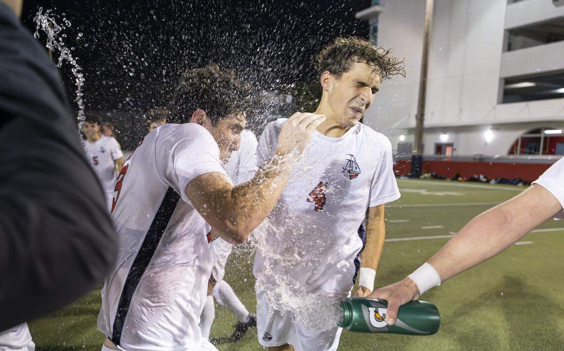 Columbus Explorers Sebastian Tamargo (4) and Mauricio Gonzalez (13) celebrate with their teammates after they defeated the Doral Academy Firebirds in their Region 4-7A semifinal playoff high school soccer game at Doral Academy on Thursday, Feb. 12, 2026, in Doral, Fla.