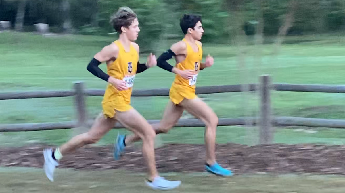 Javier Vento, right, who finished first in a personal record time of 15:21, and teammate Adam Magoulas (15:26) played key roles in Belen’s cross-country victory.