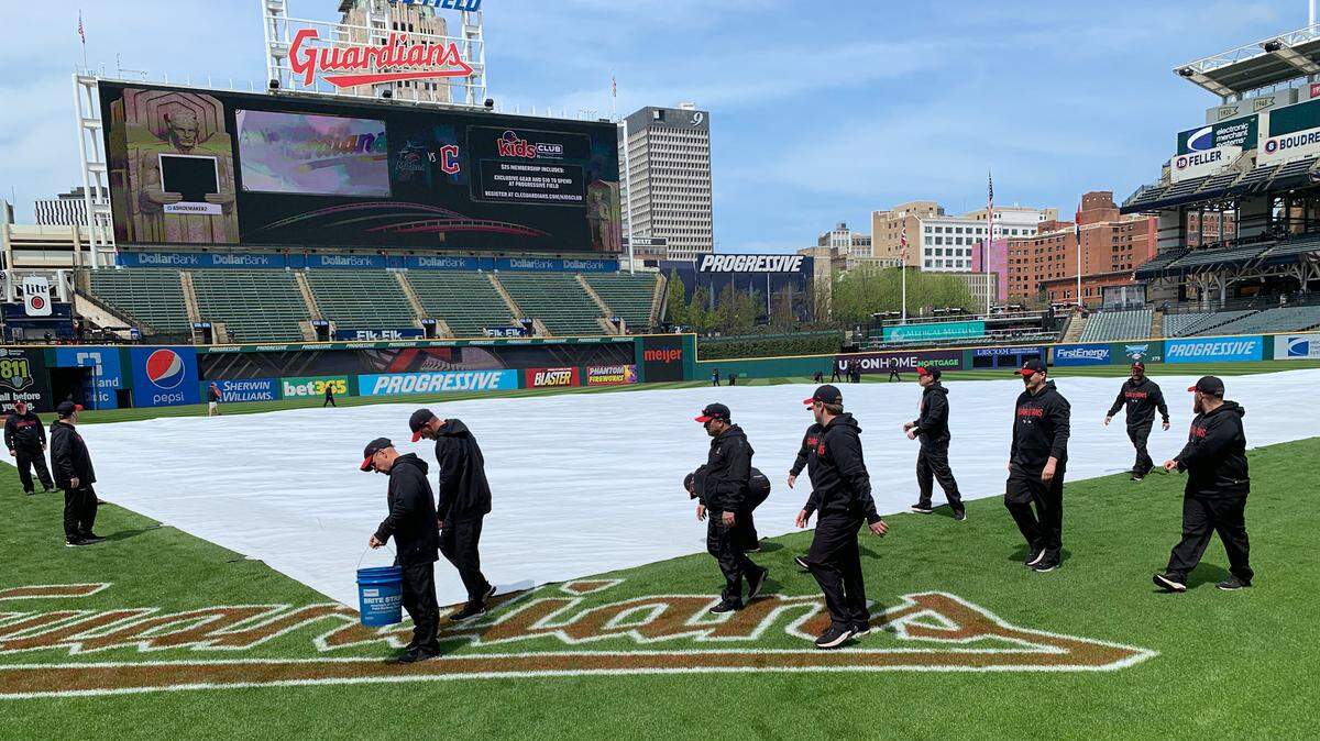 The Progressive Field grounds crew puts a tarp on the infield on Saturday, April 22, 2023.