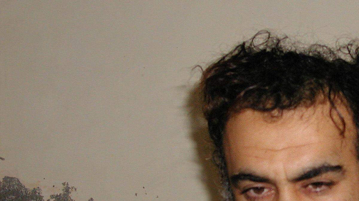 In a file photo Khalid Sheik Mohammed, the alleged Sept. 11 mastermind, is seen shortly after his capture during a raid in Pakistan Saturday March 1, 2003, in this photo obtained by the Associated Press.