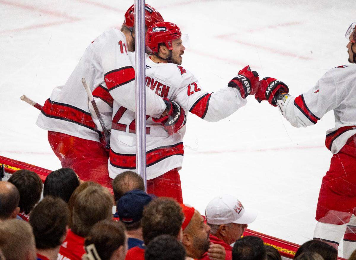 Carolina Hurricanes center Logan Stankoven (22) celebrates his goal and center Jordan Staal (11) hugs him in the second period of Game 4 during the Eastern Conference final of the NHL Stanley Cup playoffs at the Amerant Bank Arena on Monday, May 26, 2025 in Sunrise, Fla.