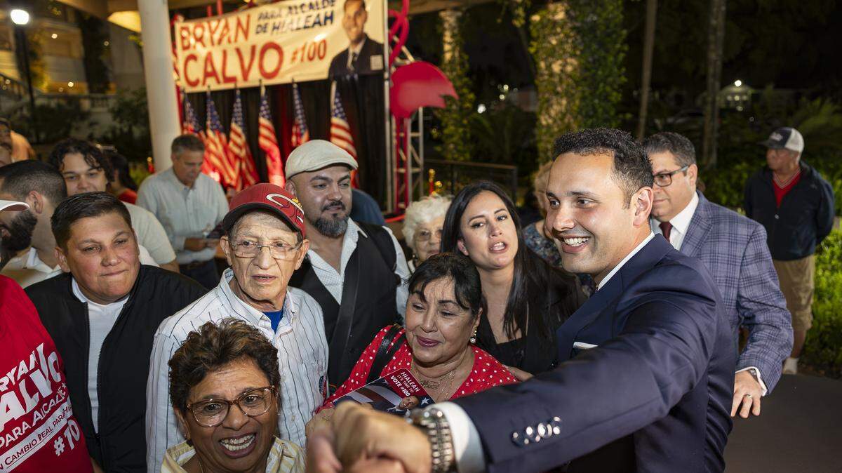 Newly elected Hialeah Mayor Bryan Calvo hugs supporters after defeating Interim Mayor Jackie Garcia-Roves during his election night party at Hialeah Park Casino on Tuesday, Nov. 4, 2025, in Hialeah, Fla.