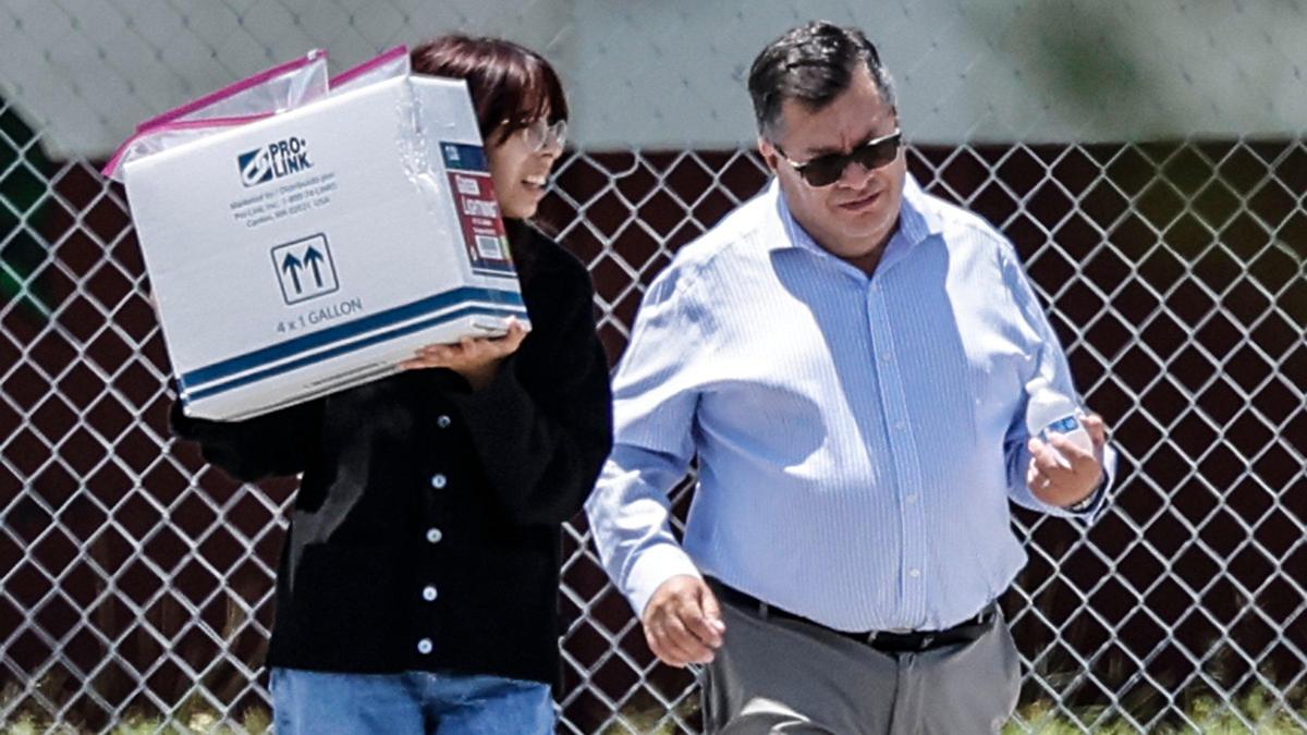 Survivor Isabel Chequer, is seen carrying a cardboard box as she leaves the 1200 building of Marjory Stoneman Douglas High School on Thursday, July 6, 2023. Chequer, a student during the Parkland shooting on Valentine’s Day in 2018, told jurors she was grazed by bullets then hid behind a filing cabinet.