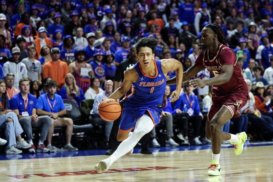 GAINESVILLE, FLORIDA - NOVEMBER 11: Xaivian Lee #1 of the Florida Gators drives to the basket against Robert McCray V #6 of the Florida State Seminoles during the first half of a game at the Stephen C. O'Connell Center on November 11, 2025 in Gainesville, Florida. (Photo by James Gilbert/Getty Images)