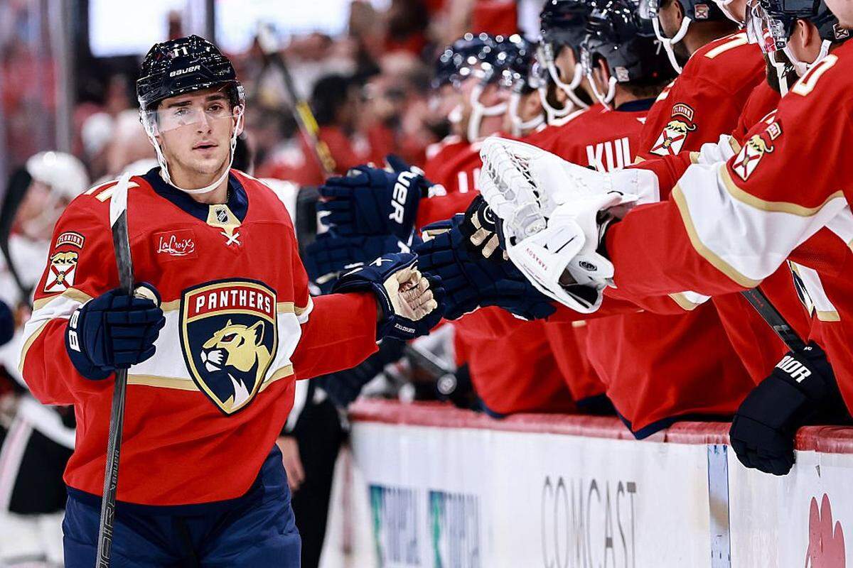 SUNRISE, FLORIDA - OCTOBER 07: Mackie Samoskevich #11 of the Florida Panthers high fives teammates against the Chicago Blackhawks during the first period at Amerant Bank Arena on October 07, 2025 in Sunrise, Florida. (Photo by Carmen Mandato/Getty Images)