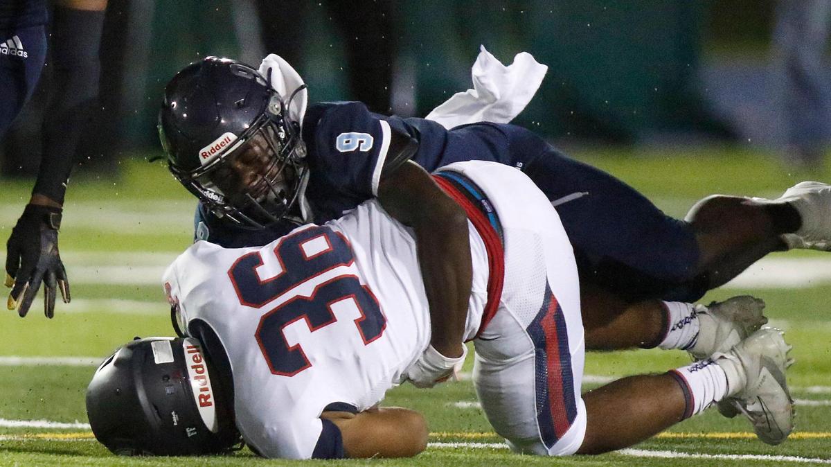 Palmetto Panthers Cameron Sapp (9) takes down Columbus Explorers running back Lucas Wolinsky (36) during football game Friday, Oct. 29, 2021 at Traz Powell Stadium in Miami. Andrew Uloza / for THE MIAMI HERALD