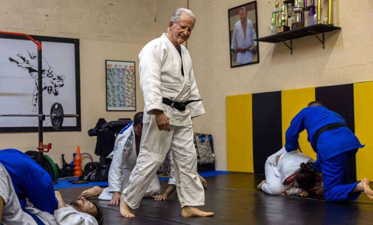 Peter Iglesias, Baragua Judo Kai instructor, walks the mat while watching students spar at Baragua Judo Kai in Miami, Fla., on Wednesday, June 3, 2026.