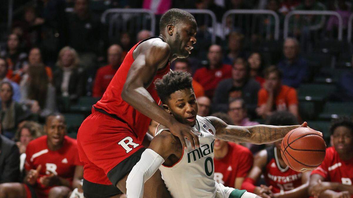 Hurricanes’ Chris Lykes (0) drives past Rutgers’ Eugene Omoruyi (5) Wednesday Nov. 28, 2018, at the Watsco Center in Coral Gables, Fla.