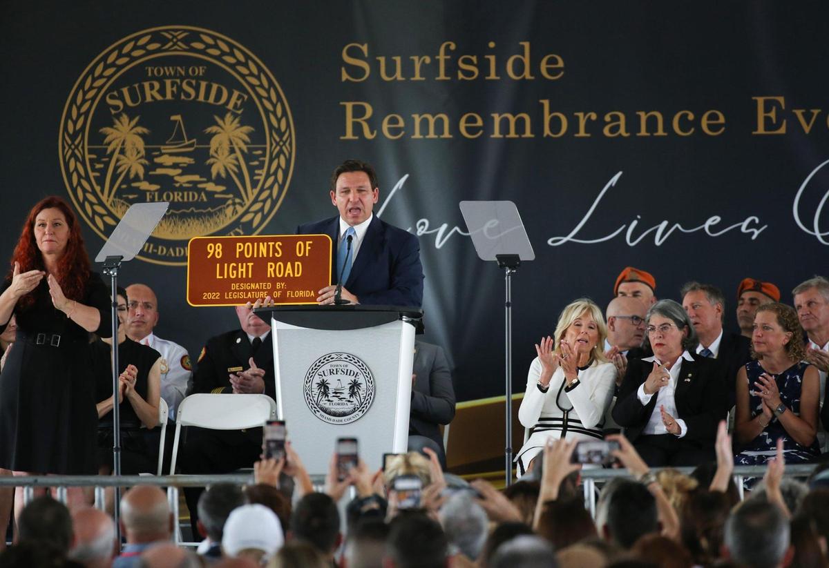 Florida Governor Ron DeSantis reveals a road sign honoring the memory of the lives lost during a public memorial to mark the one-year anniversary on Friday, June 24, 2022, of the collapse of Champlain Towers South in Surfside, Florida.