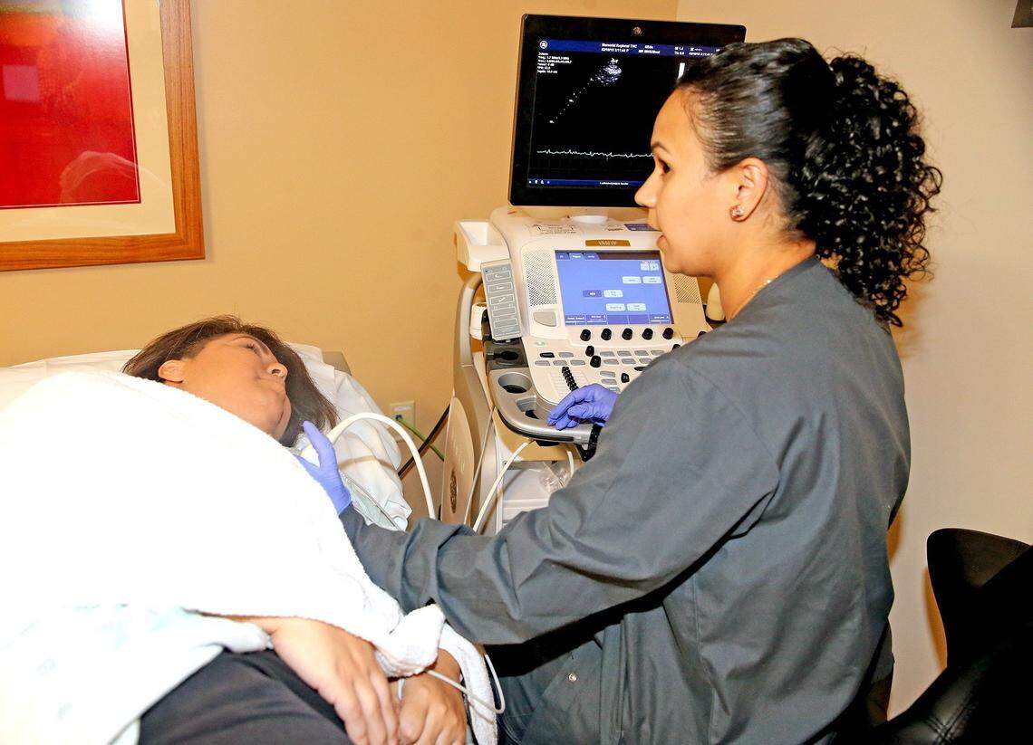 Technologist Sue Olsen gives Kristin Stanley-Motzner an electrocardiogram at The Total Heart Center at Memorial Regional Hospital. Stanley-Motzner had chest pains shortly after she had delivered her baby son. She was 31 and was diagnosed with postpartum cardiomyopathy, a rare condition that often affects Hispanic and black women. She is Nicaraguan. On Christmas Day 2018, she received a heart transplant at Memorial Hospital. Now, her heart is expected to function fully for the next 15 to 20 years.