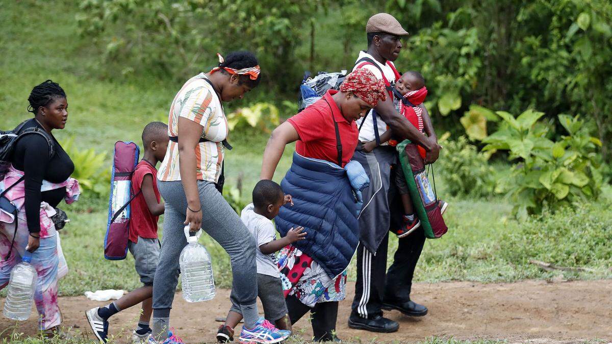 Haitian migrants walk on their way to Panama through the Darien Gap in Acandi, Colombia, in 2021.