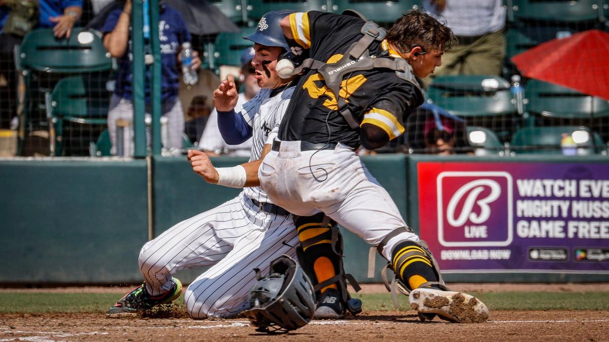 North Broward Prep Eagles Kiernan O’Neill (2) is hit by the ball as he slides safely into home plate to score as Fort Myers Bishop Verot Vikings catcher Carter Chalder (24) fails to make the tag in the second inning during the FHSAA Baseball Class 3A State Semifinal at Hammond Stadium in Fort Myers, Florida on Tuesday, May 21, 2024.