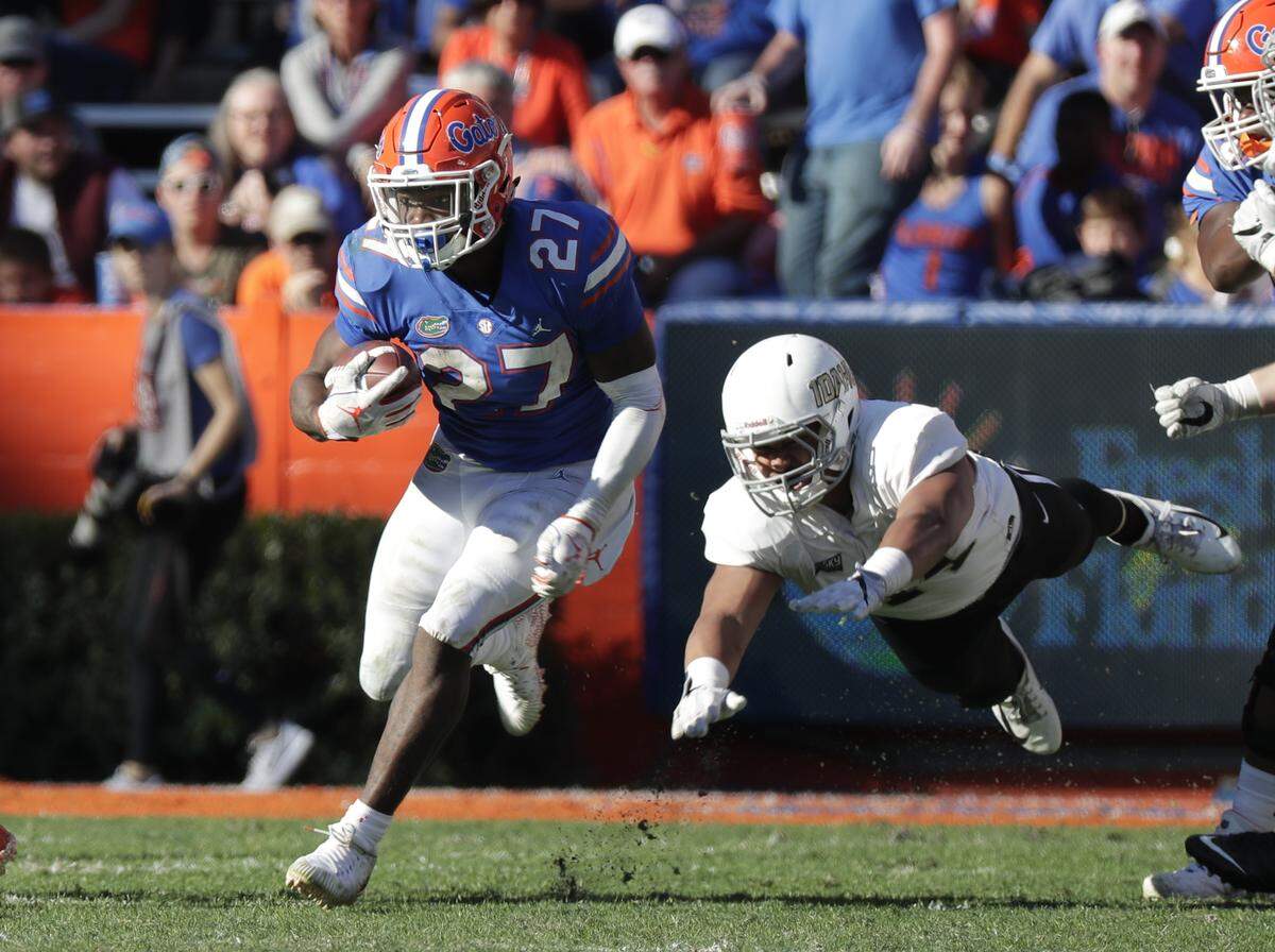Florida running back Dameon Pierce (27) runs past Idaho defensive lineman Ben Taliulu for yardage during the second half of an NCAA college football game, Saturday, Nov. 17, 2018, in Gainesville, Fla.