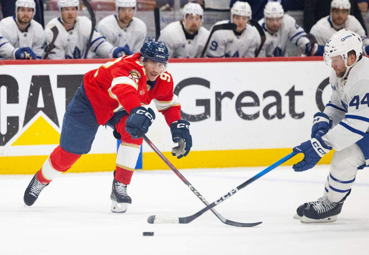 Florida Panthers left wing Tomas Nosek (92) goes after the puck against Toronto Maple Leafs defenseman Morgan Rielly (44) during the third period of Game 4 of a Stanley Cup playoffs second-round series on Sunday, May 11, 2025, at Amerant Bank Arena in Sunrise, Fla. The Florida Panthers won 2-0. 