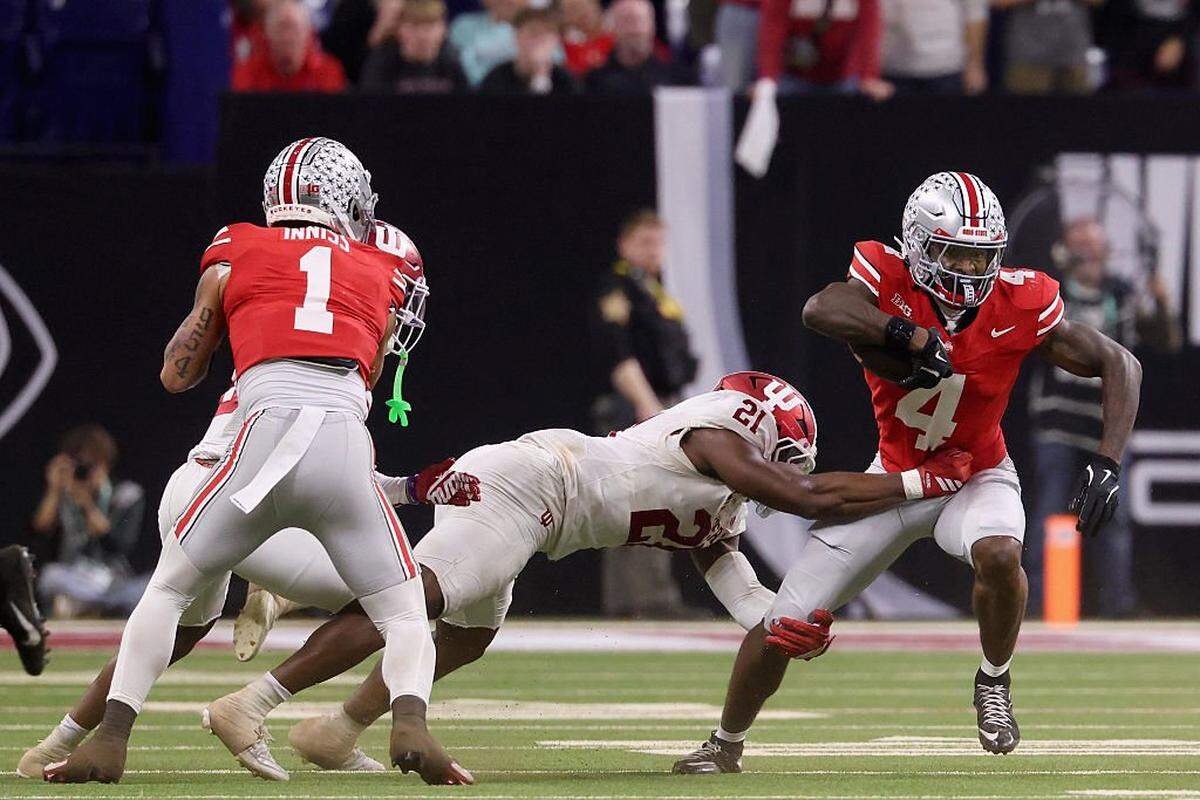 INDIANAPOLIS, INDIANA - DECEMBER 06: Rolijah Hardy #21 of the Indiana Hoosiers tackles Jeremiah Smith #4 of the Ohio State Buckeyes during the third quarter in the 2025 Big Ten Football Championship at Lucas Oil Stadium on December 06, 2025 in Indianapolis, Indiana. (Photo by Justin Casterline/Getty Images)