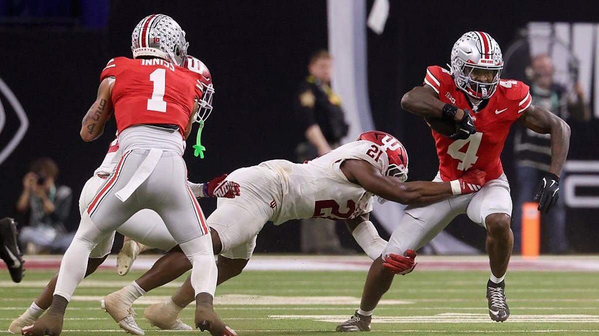 INDIANAPOLIS, INDIANA - DECEMBER 06: Rolijah Hardy #21 of the Indiana Hoosiers tackles Jeremiah Smith #4 of the Ohio State Buckeyes during the third quarter in the 2025 Big Ten Football Championship at Lucas Oil Stadium on December 06, 2025 in Indianapolis, Indiana.  (Photo by Justin Casterline/Getty Images)