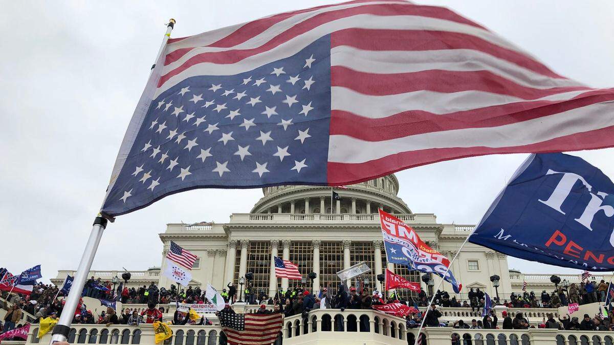 Rioters stand on the U.S. Capitol building to protest the official election of President-elect Joe Biden on Jan. 6, 2021 in Washington D.C.