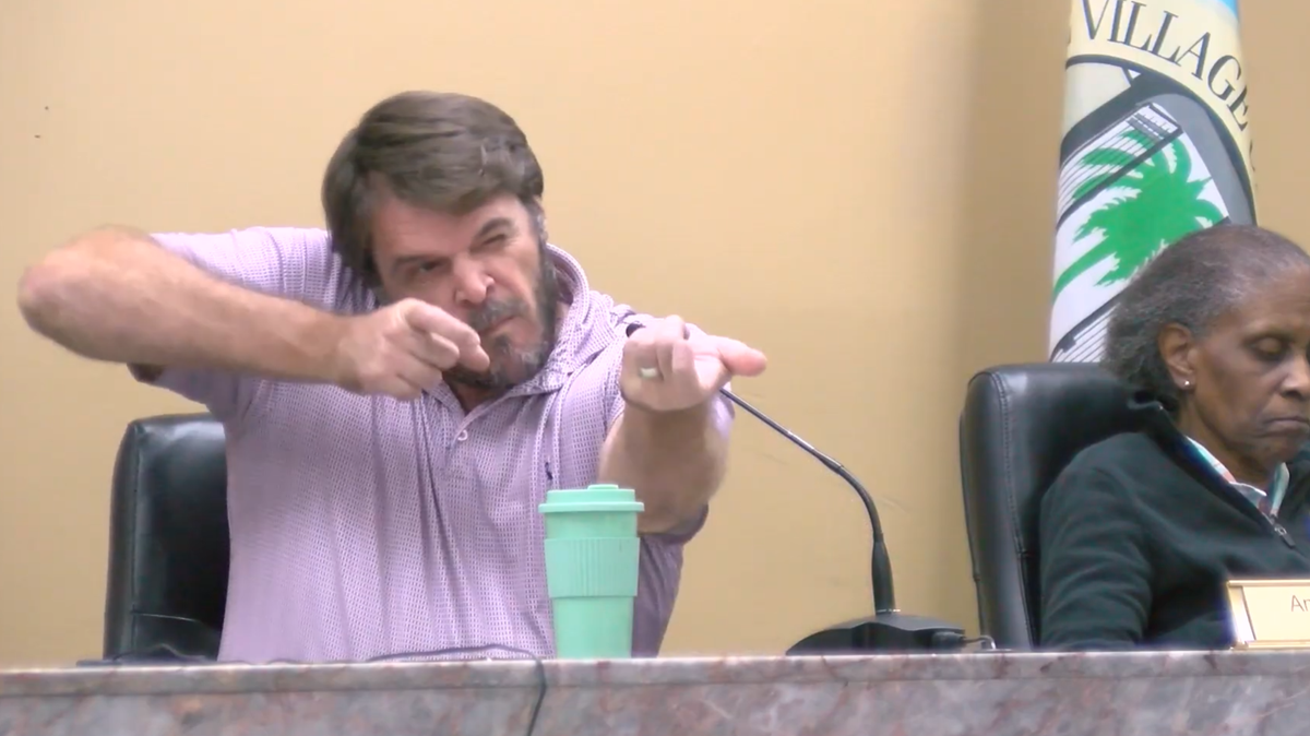 A screenshot from the Jan. 22 Village of El Portal, Florida, Planning and Zoning meeting video shows Councilman Anders Urbom closing one eye and miming a gun-aiming ‘wink’ as he repeatedly uses the N-word, while Councilperson Anna E. Lightfoot-Ward, seated beside him, looks down. This came after Urbom launched into a diatribe from the dais against ICE and Customs and Border Protection. 