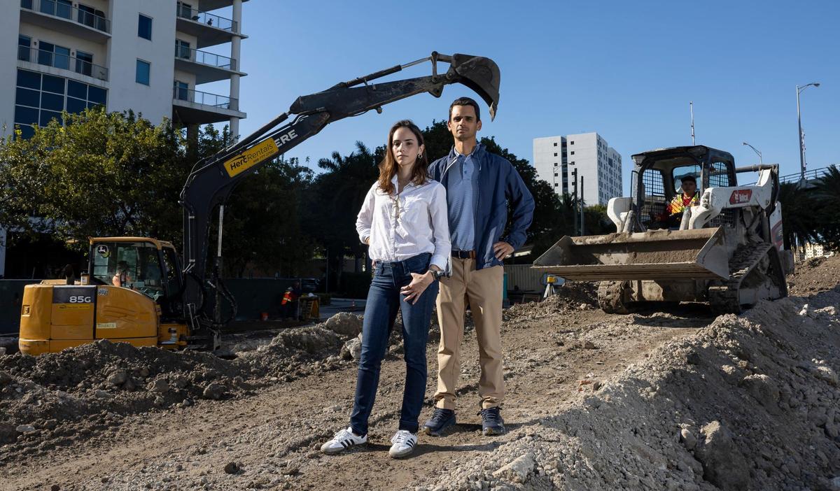 Arturo Ortega, 38, property manager of the South River Warehouse, and Veronika Ortega, 36, project architect, are photographed on their privately owned land along the Miami River on Friday, Dec. 6, 2024, in Miami, Fla. The Ortegas are in a dispute with City of Miami officials, who aim to seize their property through eminent domain to create a public park honoring Simon Bolivar.