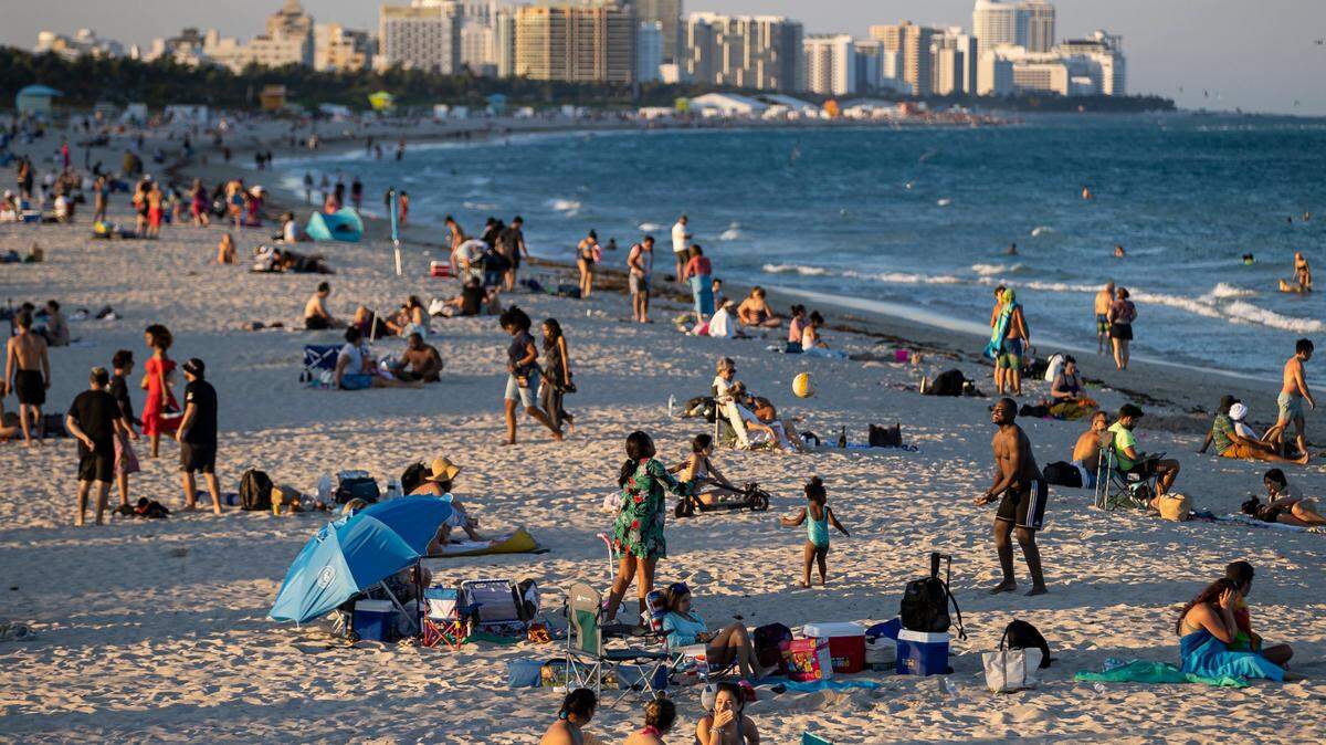 People visit South Pointe Beach on Monday, Feb. 27, 2023, in Miami Beach, Fla. St. Patrick’s Day weekend March 17-19, 2023, could turn these skies stormy.