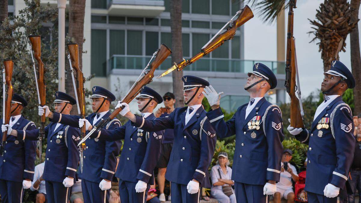 the U.S. Air Force Drill Team Honor Guard performs as attendees celebrate during Memorial Day Weekend at the Hyundai Air & Sea Show in Miami Beach, Florida, on Saturday, May 23, 2026.