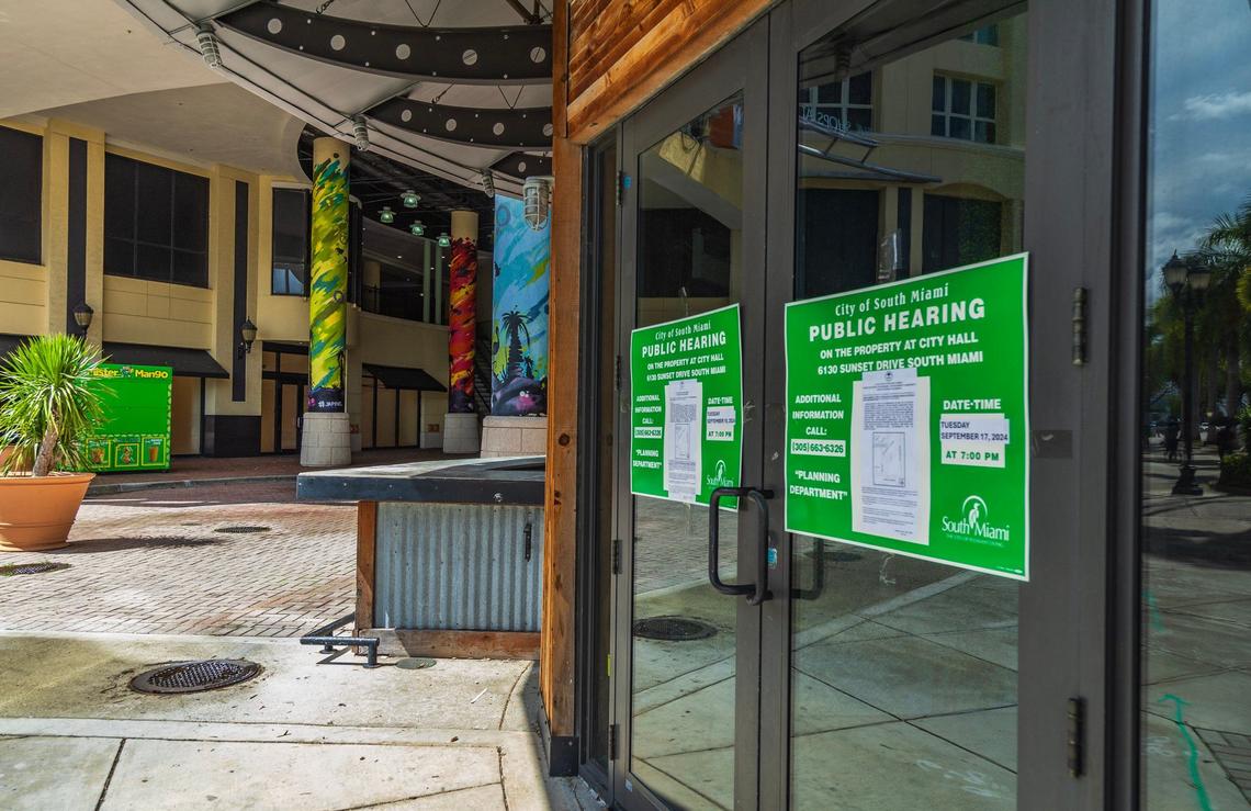 View of a public hearing notice posted by the door of an empty space inside the 25 year old Shops at Sunset Place in South Miami on Sept. 11, 2024. The mall complex may be torn down and redeveloped as a mixed use residence/office space/hotel and retail/restaurant location.