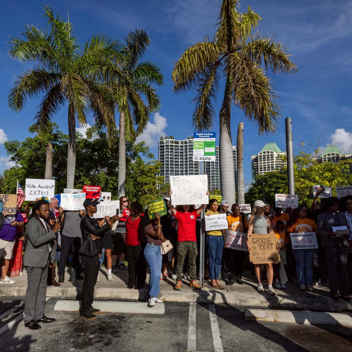 Demonstrators hold signs in protest during a press conference hosted by ACLU Florida, Florida Rising, the Florida Immigrant Coalition and Family Action Network Movement on Tuesday, June 17, 2025, in Miami.
