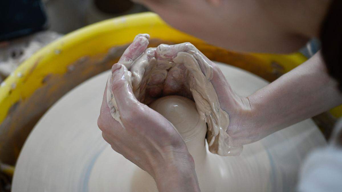 This picture taken on August 25, 2023 shows a man learning to make pottery at a workshop in Jingdezhen, China’s Jiangxi province.