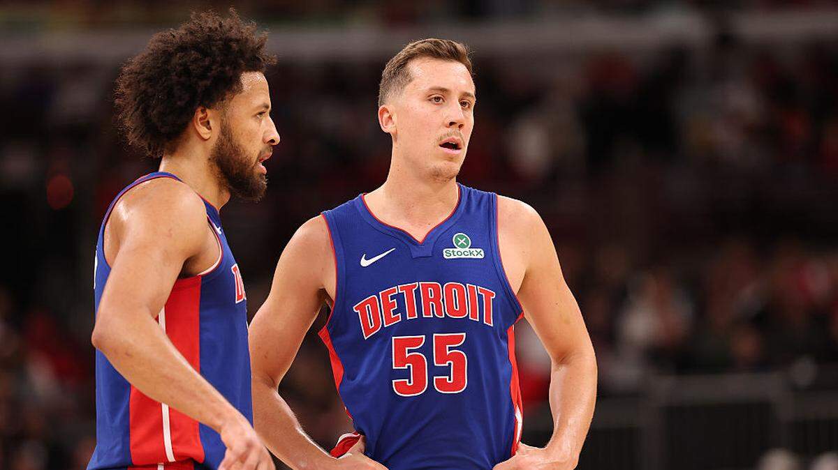 Cade Cunningham #2 and Duncan Robinson #55 of the Detroit Pistons confer during the second half at the United Center on October 22, 2025 in Chicago.